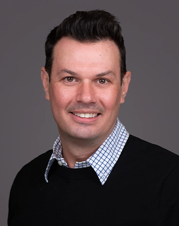 Pictured is the headshot of John Tarpinian.