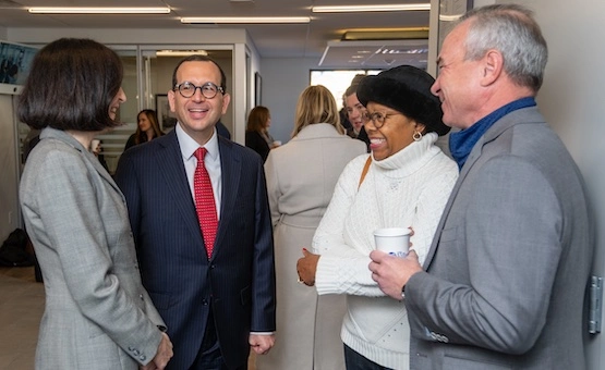 Joe speaking to people in an office.